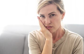 Toothache, Beautiful Woman with Tooth Infection. Young Woman Suffering From Toothache . Close up of pretty disappointed woman which having toothache.